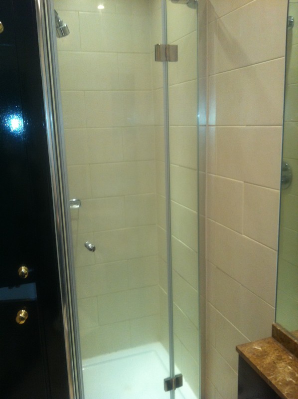 Frameless glass shower enclosure with chrome fittings in Roehampton