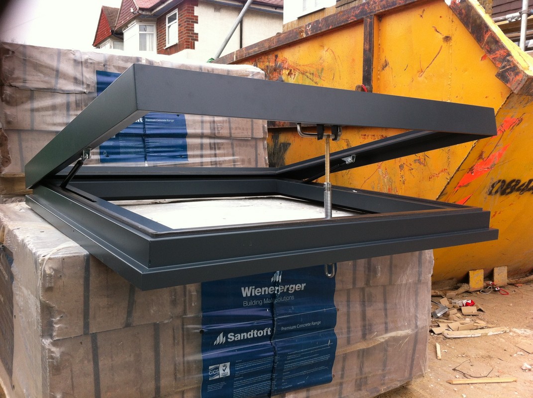 Opening flat roof skylight in anthracite grey installed in Roehampton